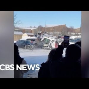 Video reveals man ramming skid loader into police cruiser in Nebraska
