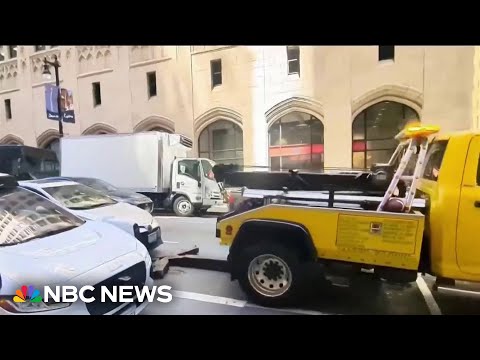 Video exhibits truck attempting to tow vehicle with driver inside